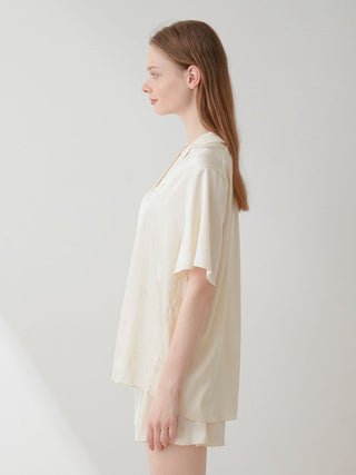 Side view of woman wearing a Flower Satin Pajama Sleep Shirt by Gelato Pique, showcasing elegant design and luxurious comfort.