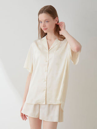 Woman wearing elegant Flower Satin Pajama Sleep Shirt with delicate floral print, showcasing luxury and comfort in sleepwear.