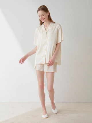 Model wearing Flower Satin Pajama Sleep Shirt with floral print by Gelato Pique, showcasing elegant and luxurious nightwear.