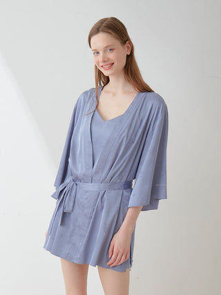Model wearing blue satin tie nightgown robe with long sleeves, showcasing elegant loungewear style.