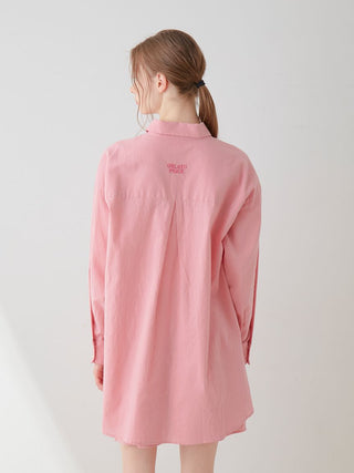 Back view of a woman wearing a pink Resort Woven Long Sleeve Oversized Shirt, showcasing its relaxed fit and high-quality woven fabric.