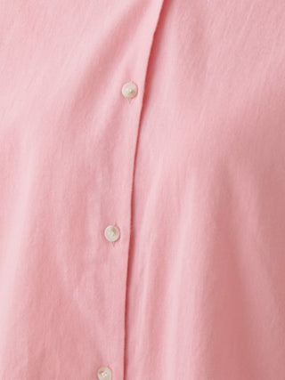 Close-up of pink woven fabric with buttons on the Resort Woven Long Sleeve Oversized Shirt.
