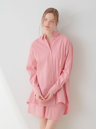 Model wearing pink Resort Woven Long Sleeve Oversized Shirt, showcasing relaxed elegance and modern style in light setting.