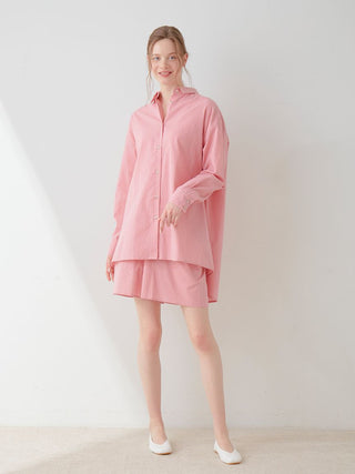Woman wearing pink Resort Woven Long Sleeve Oversized Shirt, styled elegantly for a casual chic look.