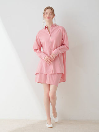 Model wearing a pink Resort Woven Long Sleeve Oversized Shirt, showcasing relaxed elegance and modern style against a white background.