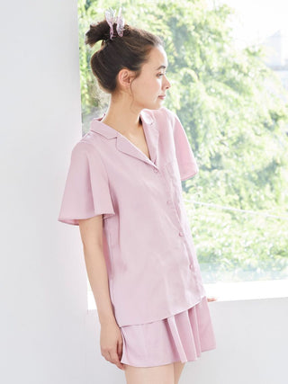 Model wearing Strawberry Embroidered Satin Sleep Shirt in natural light, showcasing smooth satin texture and button-up design.