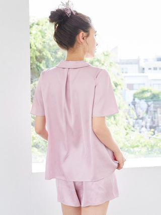 Woman wearing Strawberry Embroidered Satin Sleep Shirt from Gelato Pique, showing back design and luxurious satin fabric in light pink.