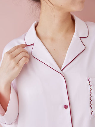 Close-up of a piping satin long sleeve pajama shirt with elegant contrast piping detail on collar and pocket.