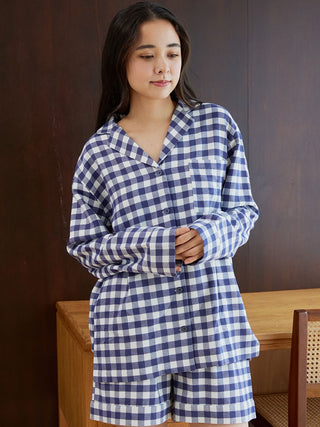 Woman wearing checkered long sleeve sleep shirt, showcasing cozy and elegant loungewear in a classic pattern for restful nights.