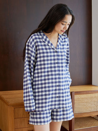Woman wearing a Gelato Pique checkered long sleeve sleep shirt, showcasing comfortable and elegant sleepwear fashion.