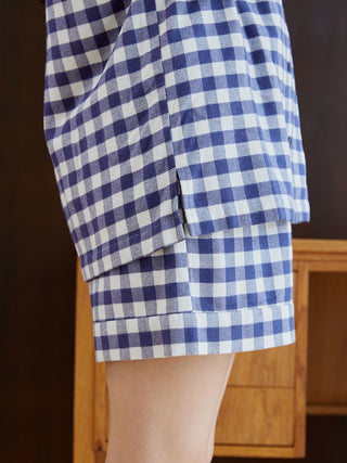 Close-up of checkered long sleeve sleep shirt, showcasing the elegant blue and white pattern and soft fabric.