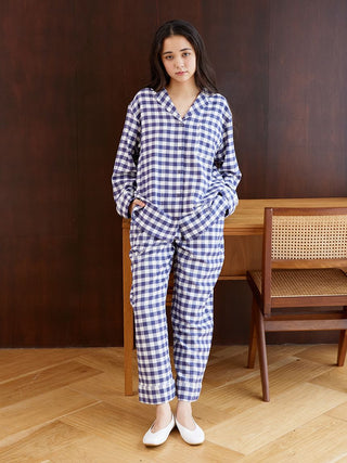 Model wearing Gelato Pique's checkered long sleeve sleep shirt and pants, showcasing a cozy and stylish sleepwear design.
