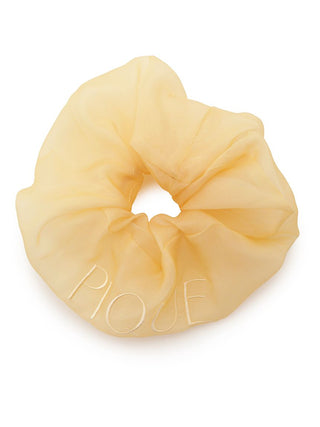Sheer color hair scrunchie with 'PIQUE' embroidery in translucent fabric, beige hue, perfect for an elegant and stylish look.