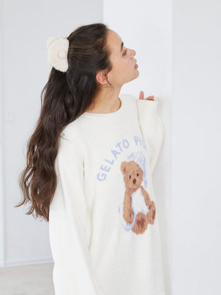 Woman wearing a Gelato Pique bear-themed hair clip in fluffy fabric, styled with long wavy hair and matching teddy bear sweater.