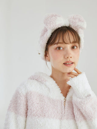 Woman wearing Gelato 2 Border Headband with pastel pink and creamy white stripes, matching fluffy jacket, chic loungewear accessory.