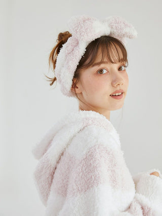 Woman wearing a Gelato 2 Border Headband with fluffy fabric, featuring pastel pink and creamy white stripes, paired with matching loungewear.