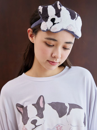 Woman wearing a Sleeping Dog eye mask and matching shirt, showcasing playful design and comfort by Gelato Pique.