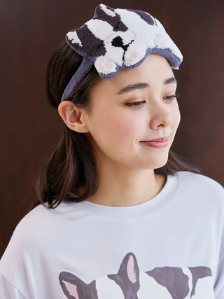 Woman wearing SLEEPING DOG Eye Mask with playful dog motif, showcasing Gelato Pique's plush, velvety design for sleep comfort.