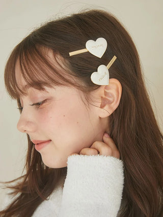 Woman wearing a Heart Hairpin Set with glossy heart motifs and gold-tone accents from Gelato Pique USA.