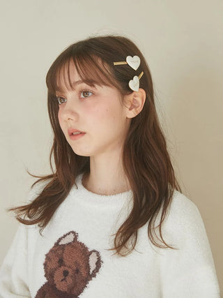 Woman wearing Gelato Pique USA Heart Hairpin Set with heart motifs and gold-tone accents, adding romantic charm to her hairstyle.