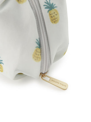 Close-up of chiffon pouch with pineapple print and zipper detail.