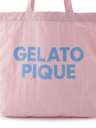 Gelato Pique pastel pink tote bag with blue text logo, chic simplicity in lightweight design.