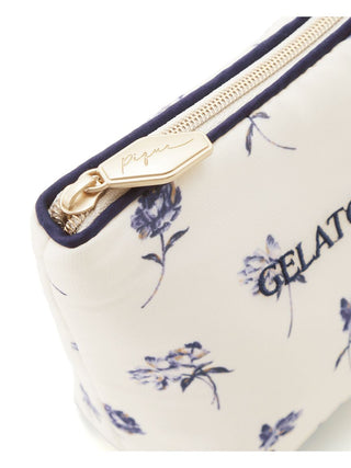 Close-up of a floral-patterned tissue pouch featuring rose prints and a branded zipper by Gelato Pique USA, elegant and functional.