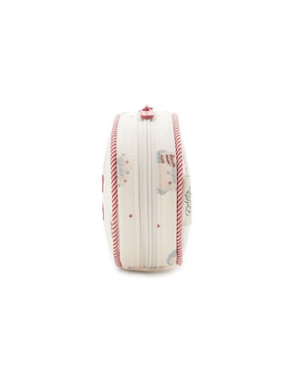 Side view of Gelato Pique Oval Pouch with decorative cake and star print, red candy-striped piping, and embroidered logo.