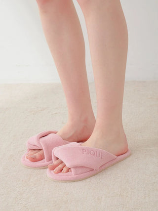 Luxurious pink pile cozy indoor slip-on bedroom slippers with a wide overlapped fabric strap for comfort and relaxation.