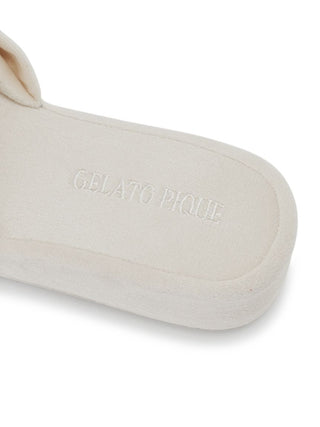 Close-up of Gelato Pique Luxury Velvet Bow Slip-On Shoes showing brand logo on soft insole.