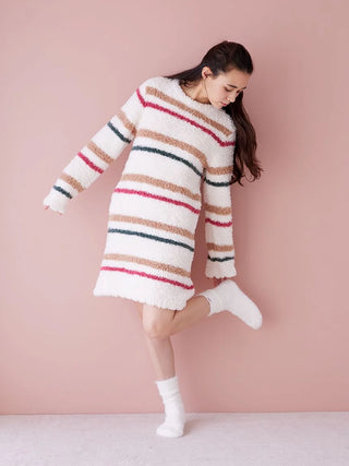Woman wearing Gelato Border Long Sleeve Lounge Dress in striped pattern, showcasing cozy loungewear style against pink background.