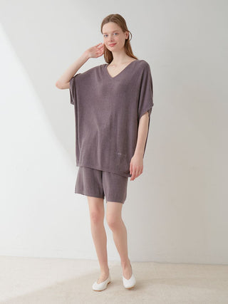 Woman wearing Smoothie Lite Lounge Shorts and matching oversized top in a soft neutral tone, showcasing cozy and luxurious comfort.