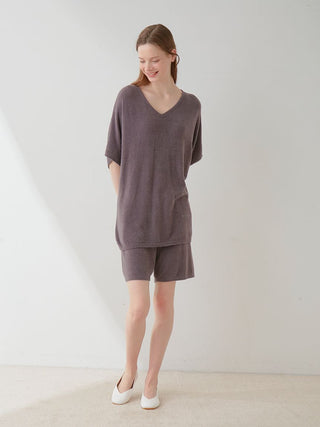 Model wearing Smoothie Lite Lounge Shorts in neutral tone, showcasing cozy charm of velvety soft fabric against serene backdrop.