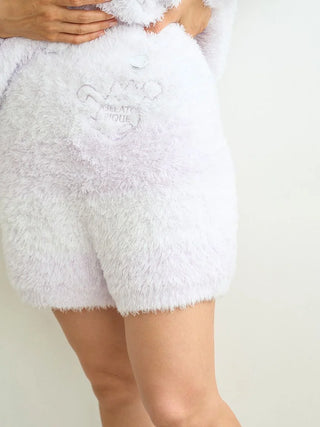Person wearing PIQUE MONSTER lounge shorts in white, featuring fluffy texture ideal for Halloween, from gelato pique collection.