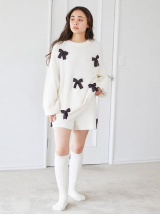 Woman wearing off-white Ribbon Lounge Shorts with black ribbons, knit material, perfect for Halloween coordination and casual wear.