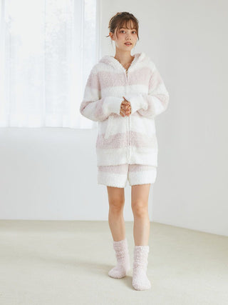 Woman wearing Gelato 2 Border Lounge Shorts with pastel two-tone border pattern and cozy socks, showcasing plush comfort.
