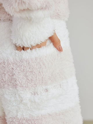 Close-up of a hand in the pocket of Gelato 2 Border Lounge Shorts, showcasing soft plush texture and two-tone pastel pattern.