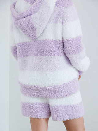 Person wearing Gelato 3 Border Lounge Shorts and hoodie in soft pink and white for cozy comfort and style.