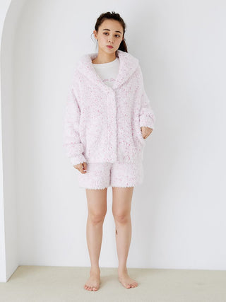 Woman wearing fuzzy lounge shorts and hoodie in delicate pink with speckled design, showcasing cozy loungewear fashion from Gelato Pique.