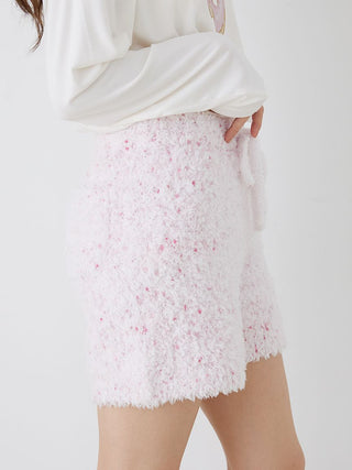 Close-up of fuzzy lounge shorts with drawstring in pink and white speckled pattern, showcasing soft textured fabric.