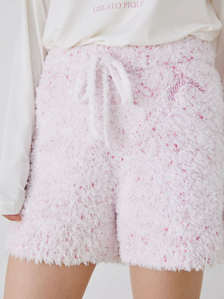 Woman wearing Gelato Pique fuzzy lounge shorts with drawstring, featuring a soft pink and white speckled design.