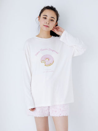 Model wearing fuzzy lounge shorts with drawstring and a donut-themed top, showcasing cozy loungewear style in light pink texture.
