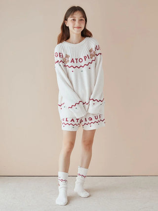 Woman wearing Nordic Lounge Shorts and sweater with 'Gelato Pique' lettering, showcasing cozy, festive, ultra-soft design.