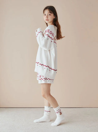 Woman wearing Nordic Lounge Shorts by Gelato Pique, showcasing festive Nordic-inspired design with red lettering, cozy home style.