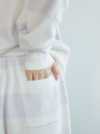 Cozy Smoothie 2-Border Lounge Shorts in plush white fabric with hand in pocket, highlighting comfort and premium style for home relaxation.