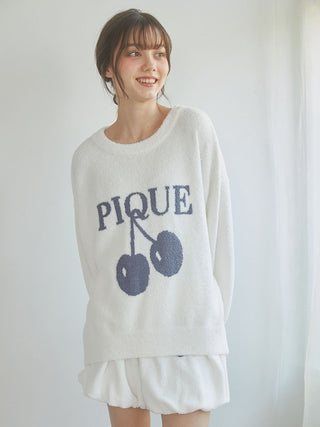 Woman wearing Air Moco Cherry Jacquard Balloon Lounge Shorts and Pique sweater, showcasing cozy loungewear.