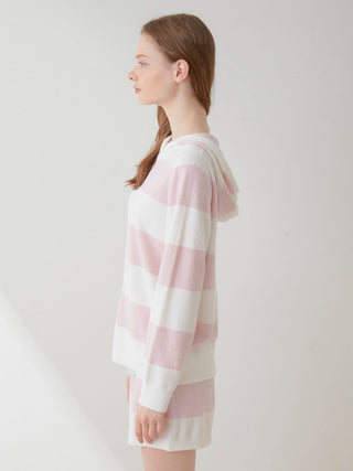 Model wearing Smoothie Lite 2-Border Zip Up Hoodie Cardigan in pastel pink and white stripes, side view.