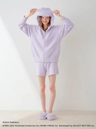 Woman wearing Pokémon Sleep Baby Moco Ditto hoodie and shorts set in light purple, showcasing comfortable and cozy style for lounging.