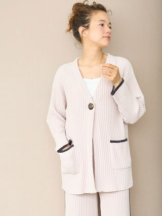 Woman wearing Air Moco x Smooth Ribbed Knit Cardigan with deep V-neck and oversized button.