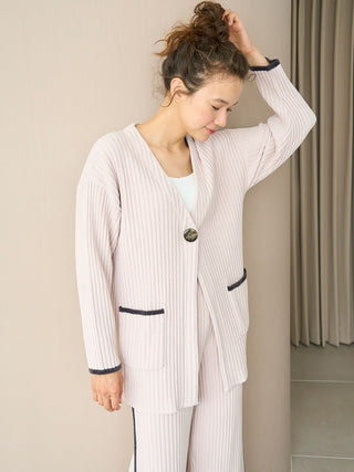 Woman wearing Air Moco x Smooth Ribbed Knit Cardigan with deep V-neckline and oversized single-button closure in soft fabric blend.
